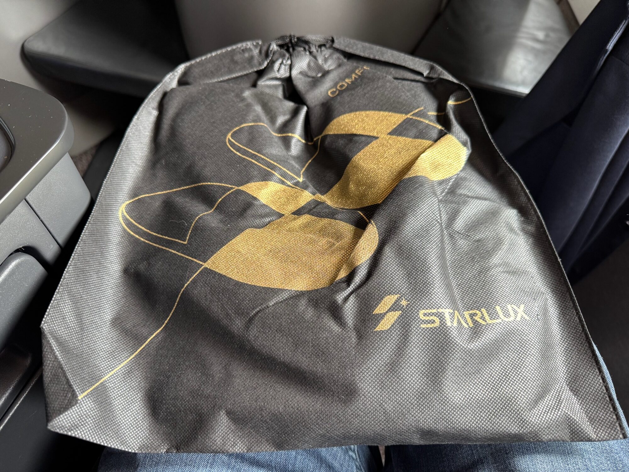 a black and gold object with a logo on it