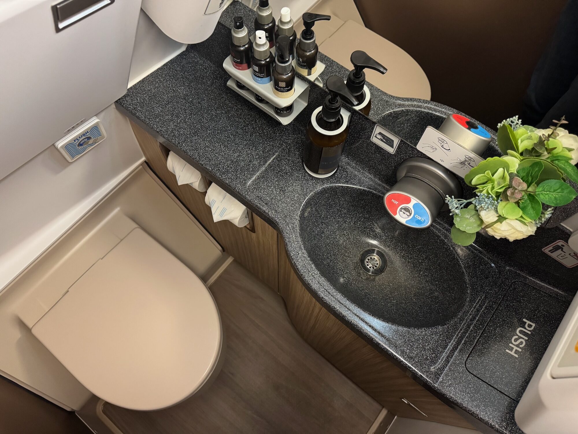a sink with bottles and a toilet