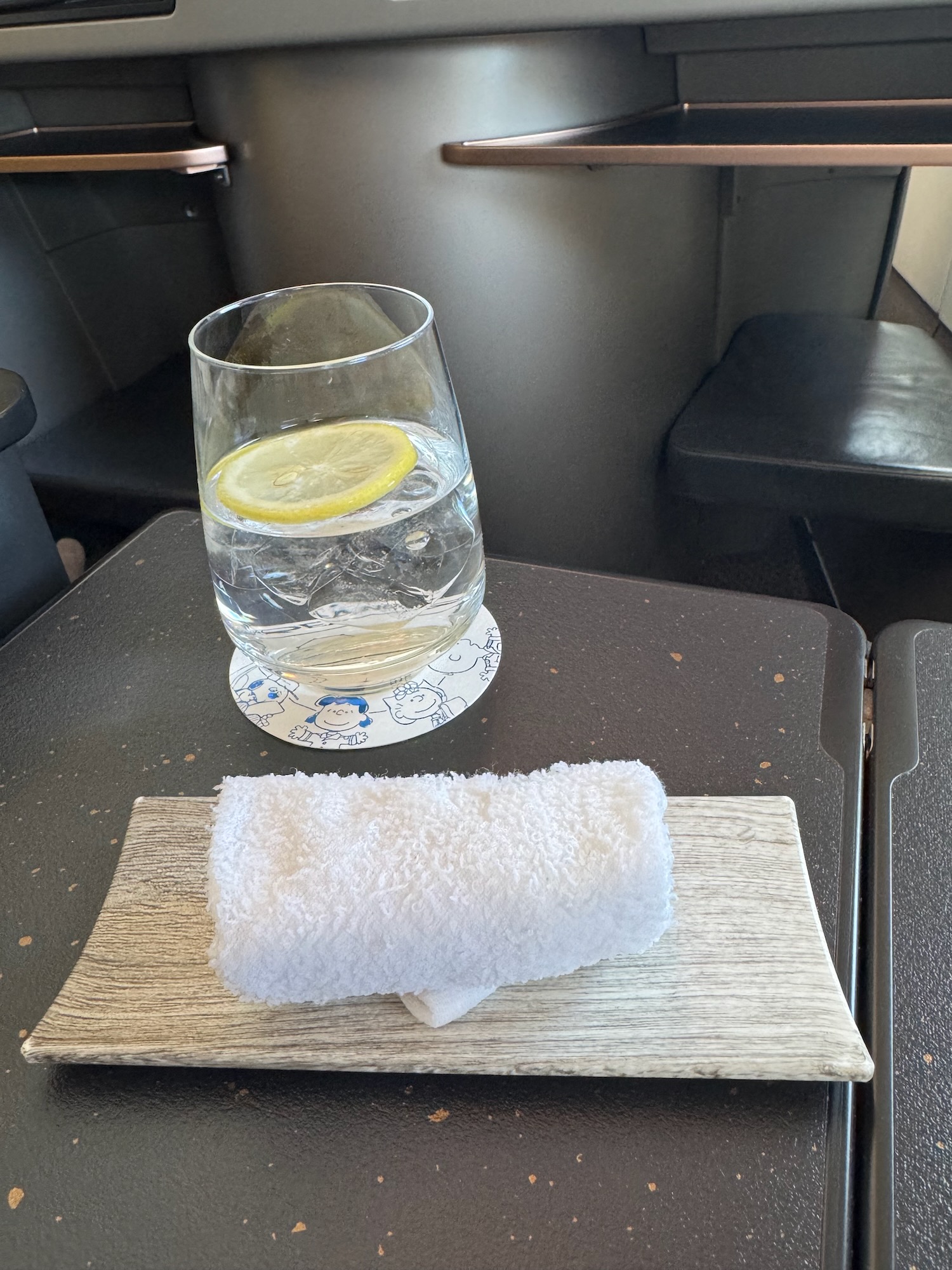 a glass of water and a towel on a table