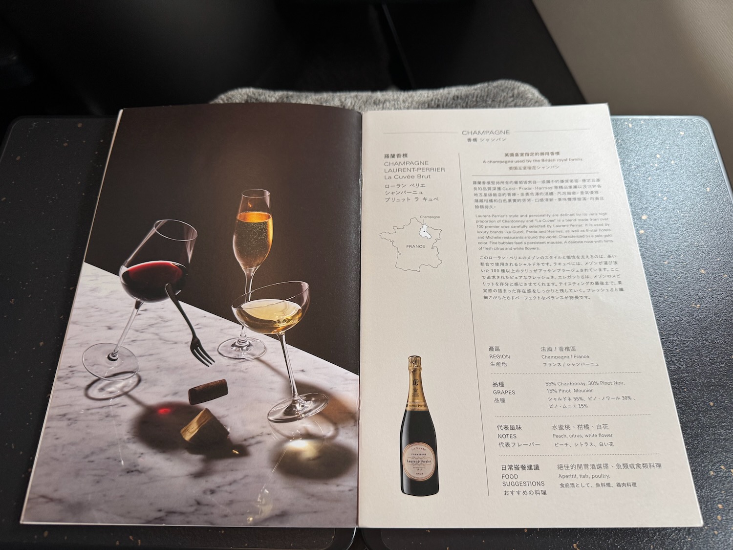 a book open to a table with wine glasses