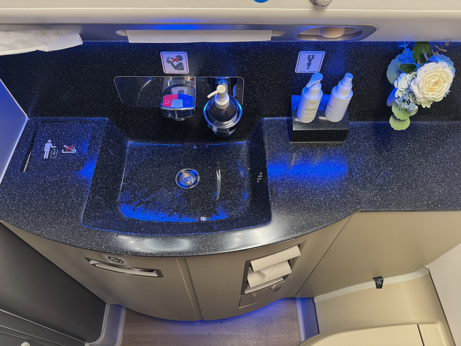 a sink with soap dispensers and bottles on top of it