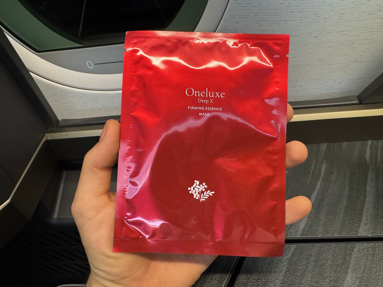 a hand holding a red package