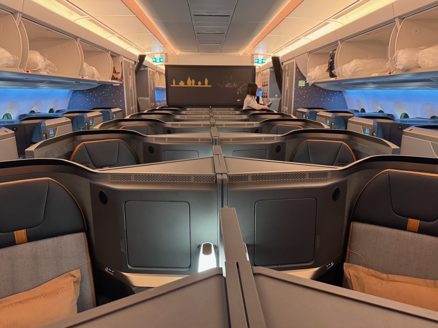 a room with rows of seats and a screen