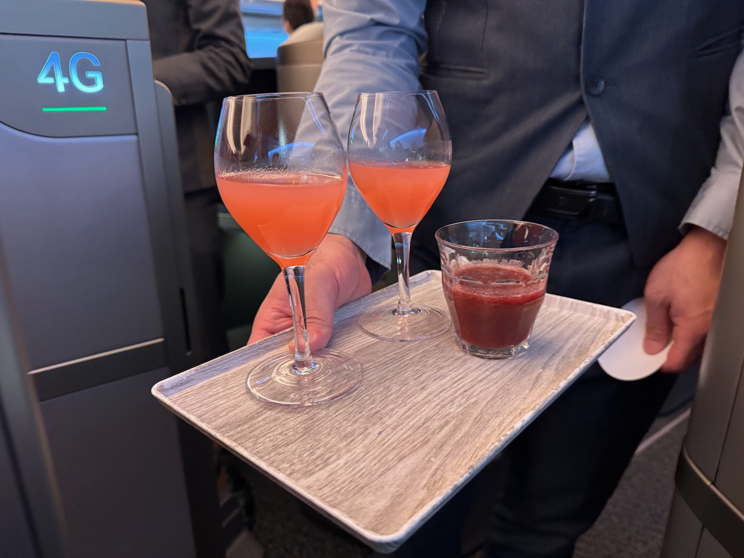 a tray with glasses of liquid and a drink on it