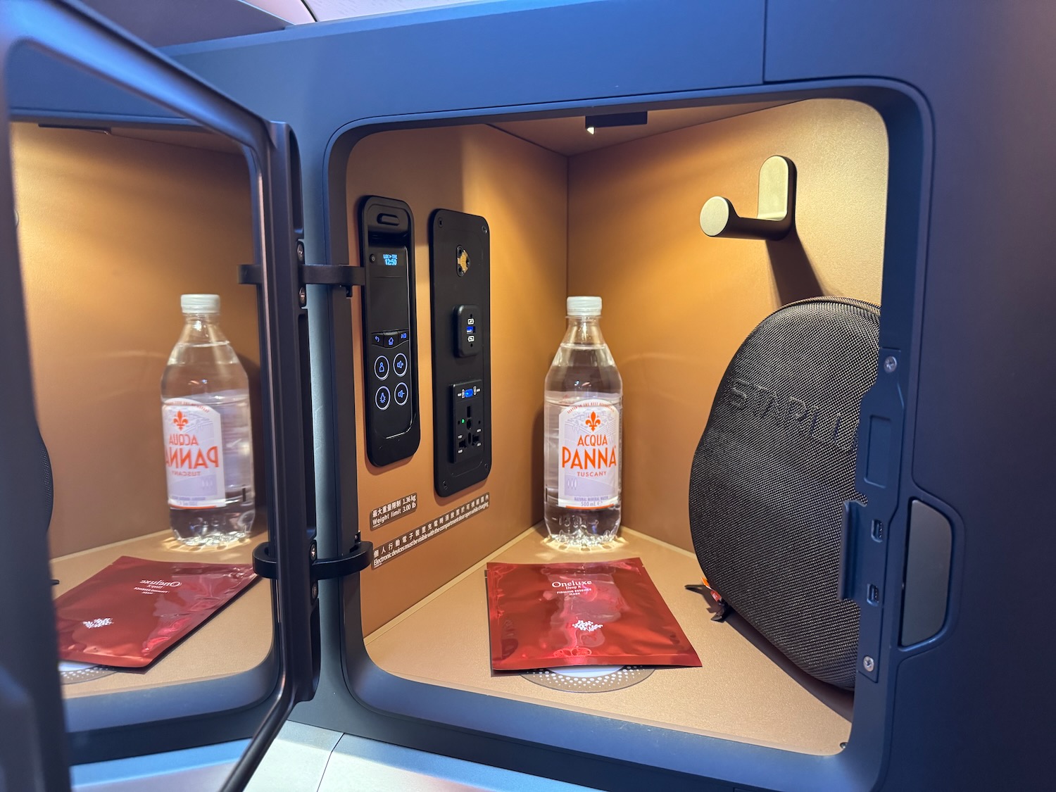 a small locker with a bottle of water and a bag of red packets