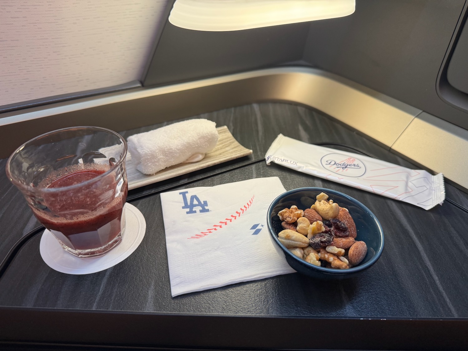 a bowl of nuts and a drink on a table