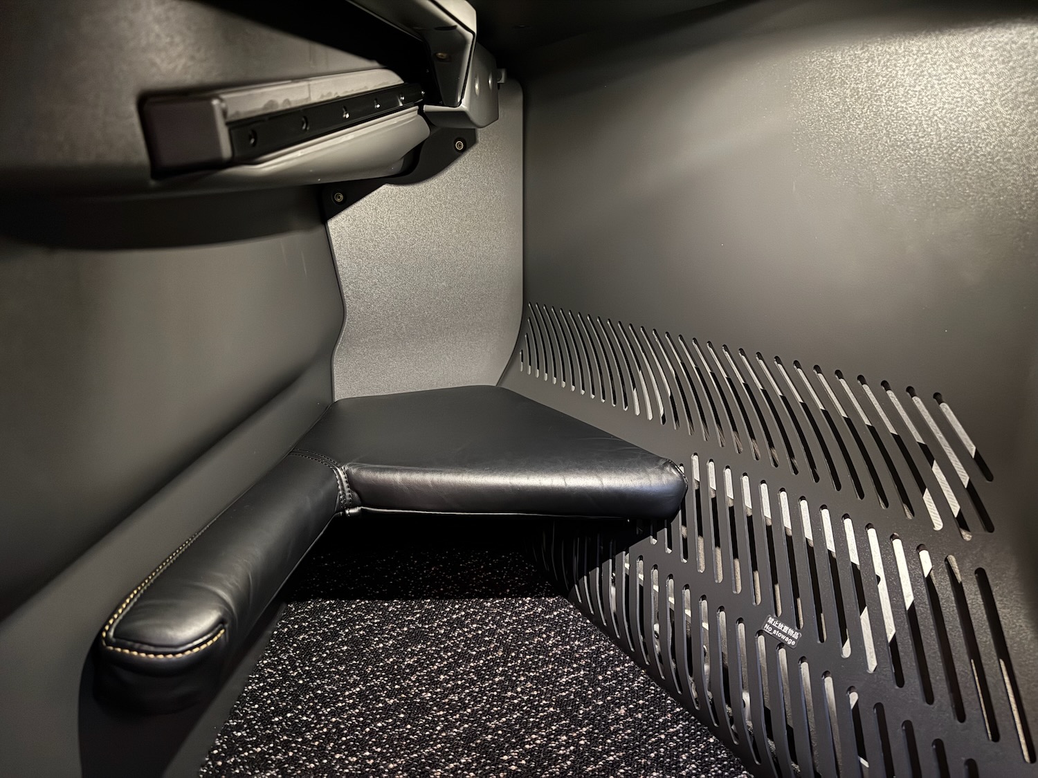 a black seat in a grey room