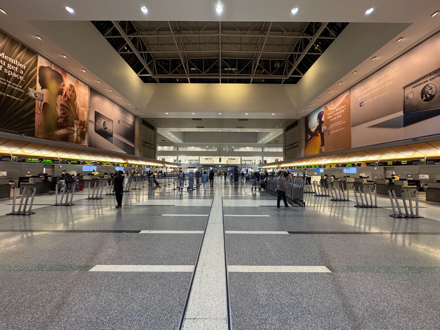a large airport terminal with people standing around