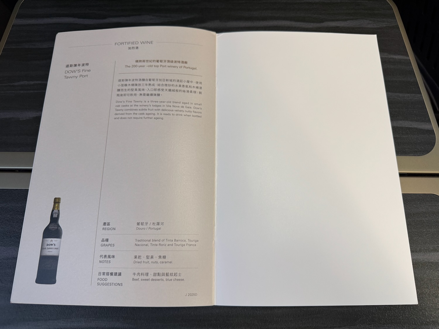 a book open with a bottle of wine