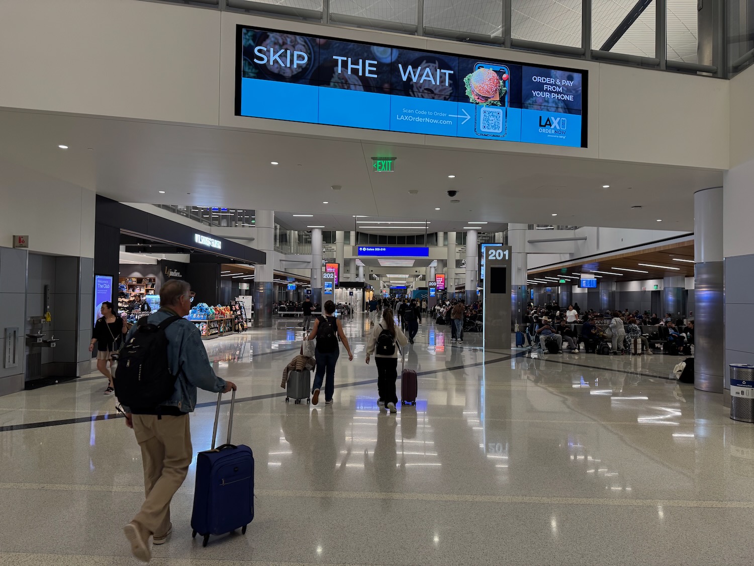 people walking in a large airport terminal