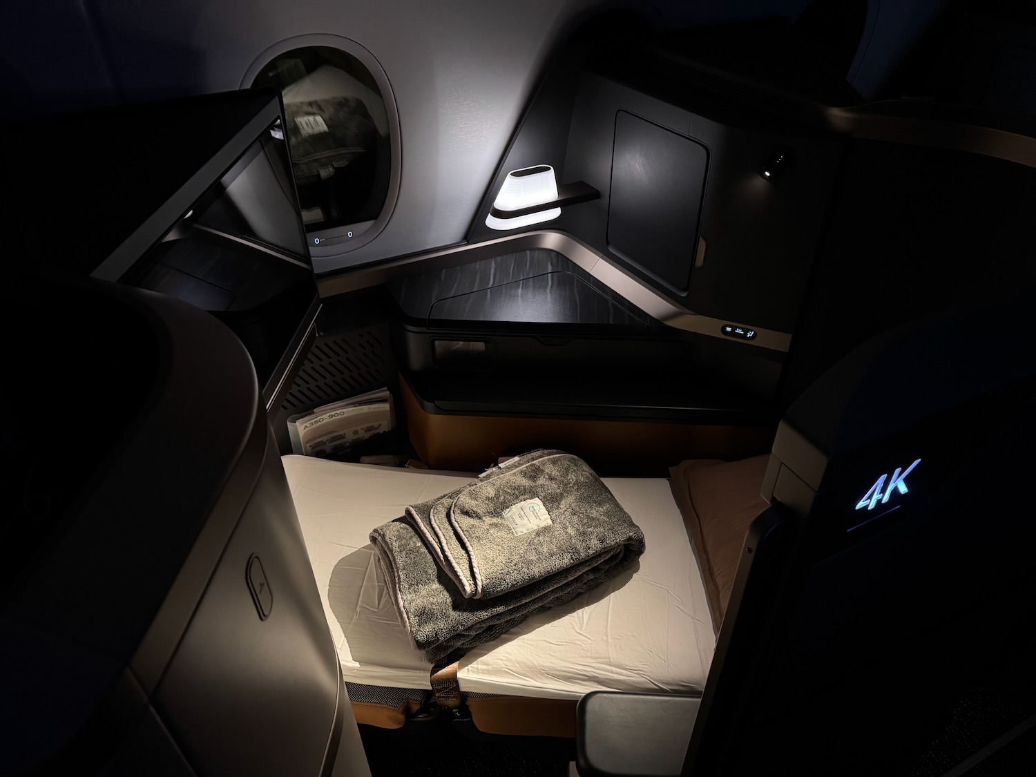 a bed in a room with a television and a blanket