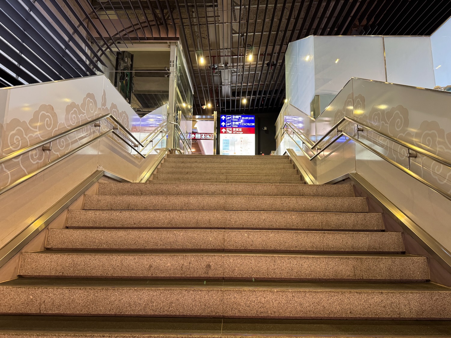 a staircase with metal handrails and a sign