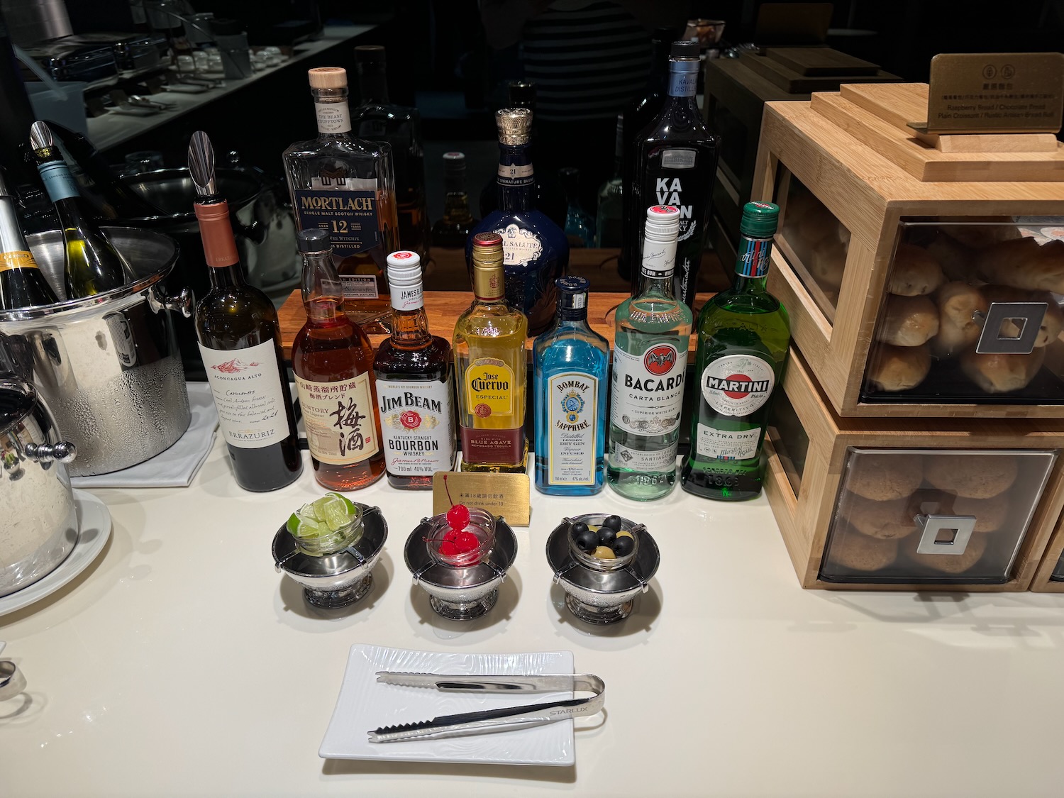 a table with bottles of alcohol and a tray of food