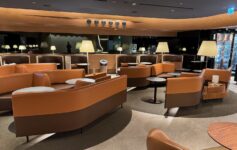 a room with brown couches and tables