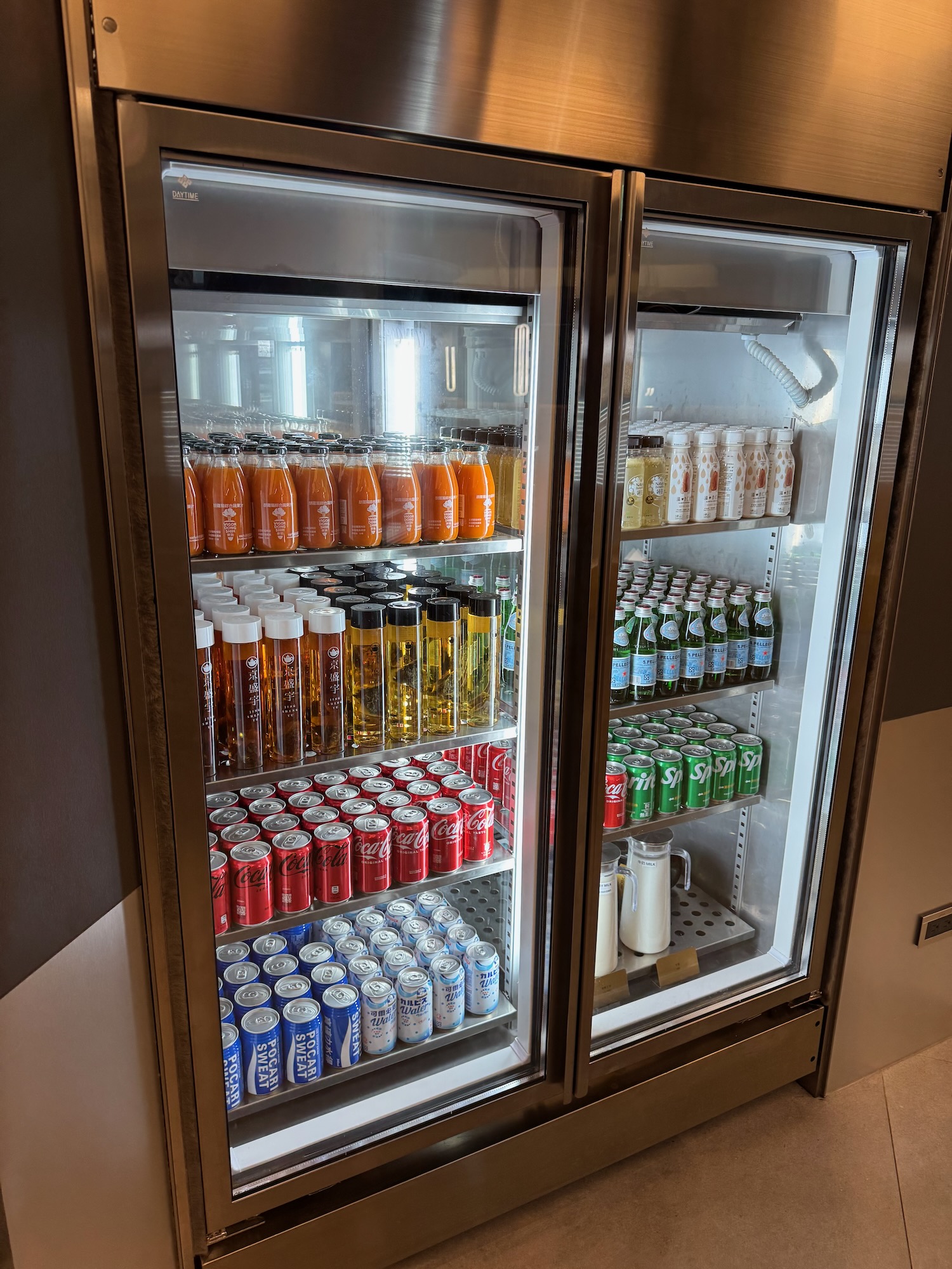 a refrigerator with drinks and cans