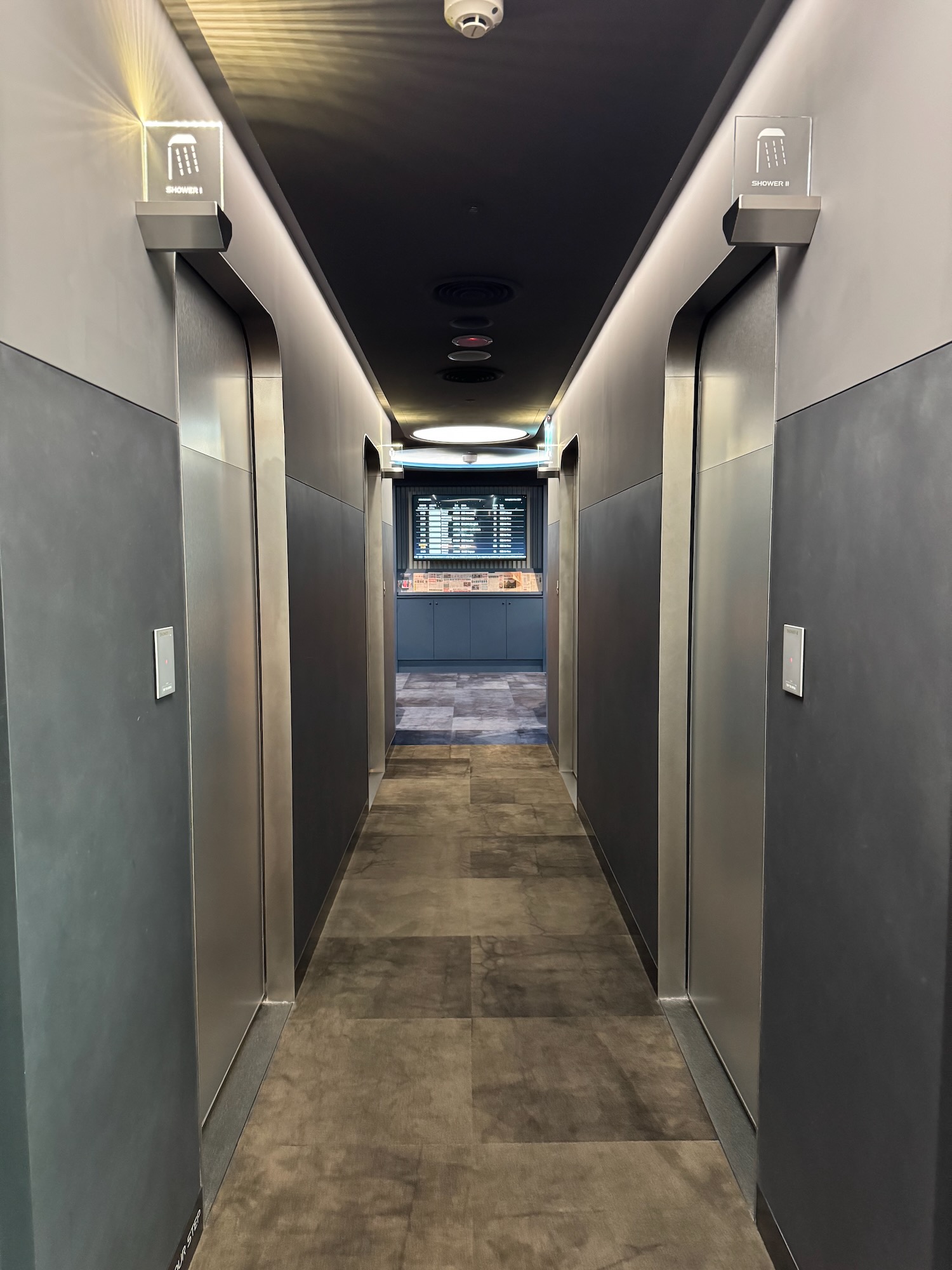 a hallway with elevators and a tv