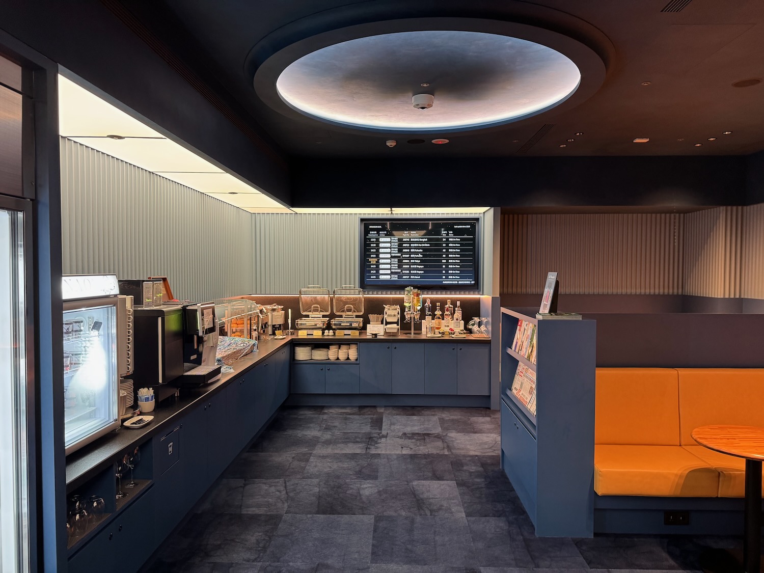 a room with a yellow couch and a screen