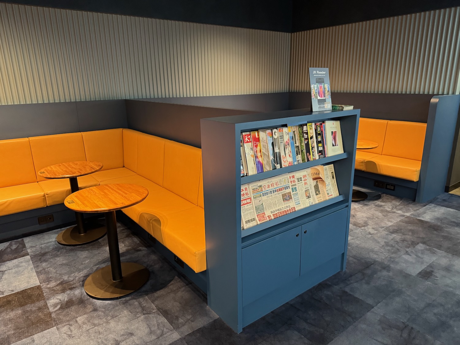 a booth with yellow seats and tables