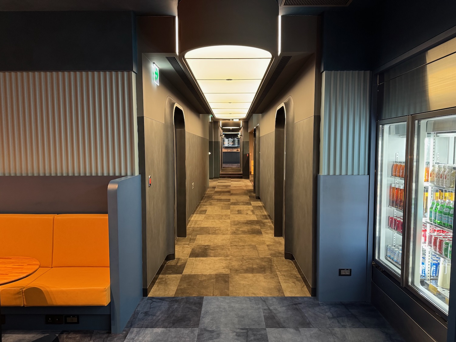 a hallway with a couch and a refrigerator