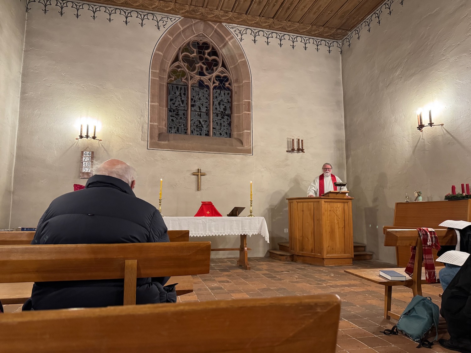 a man standing at a podium in a church