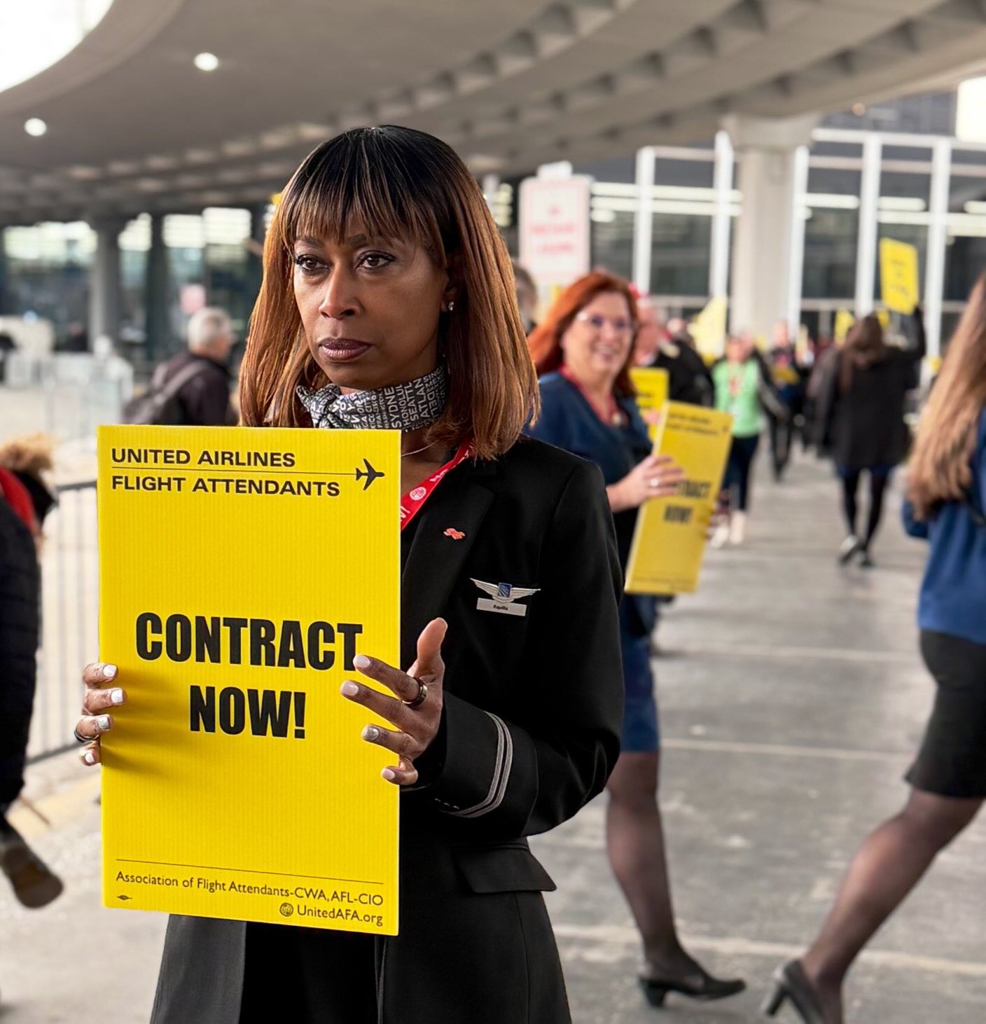 a woman holding a sign