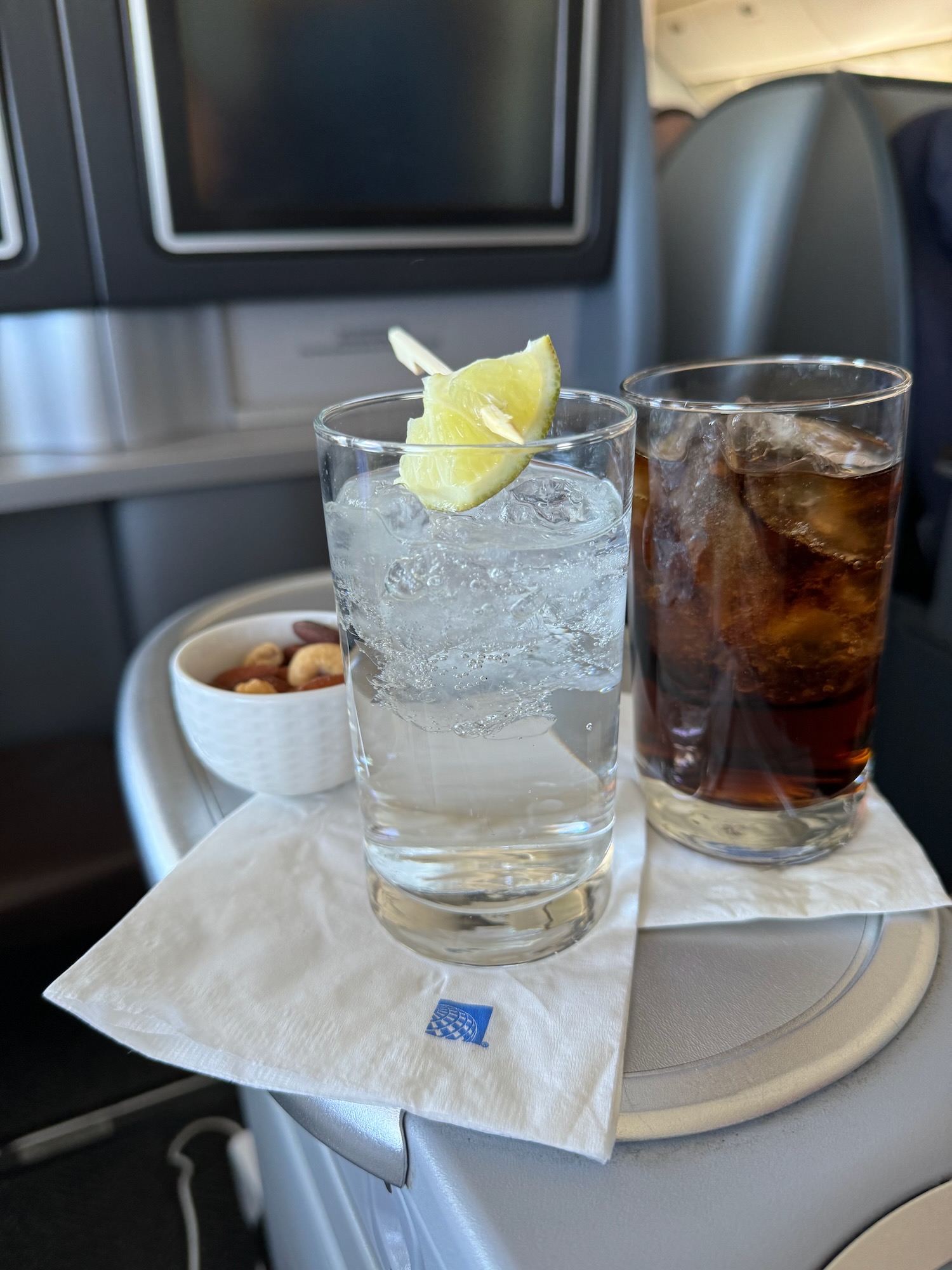 a glass of water and a lemon slice on a napkin