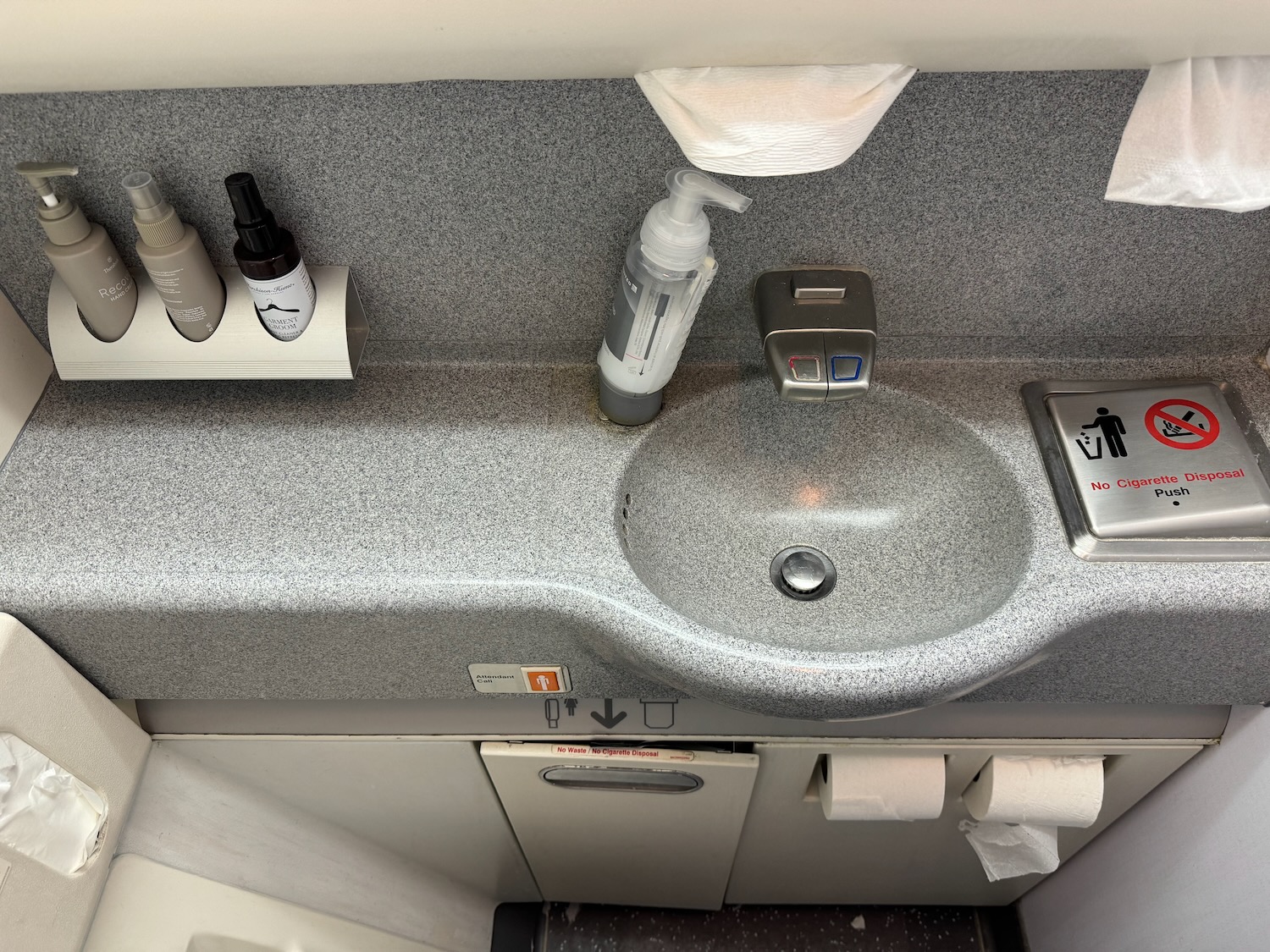 a sink with soap and soap bottles on it
