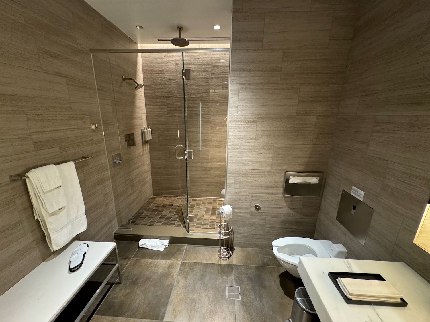 a bathroom with a glass shower and toilet