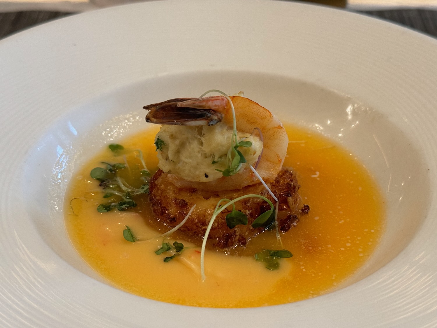 a plate of food with shrimp on top