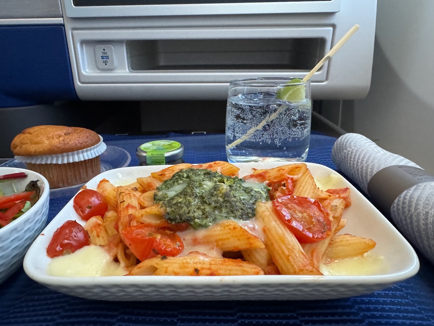 a plate of pasta and a cup of water