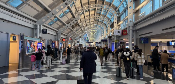 a group of people walking in a terminal