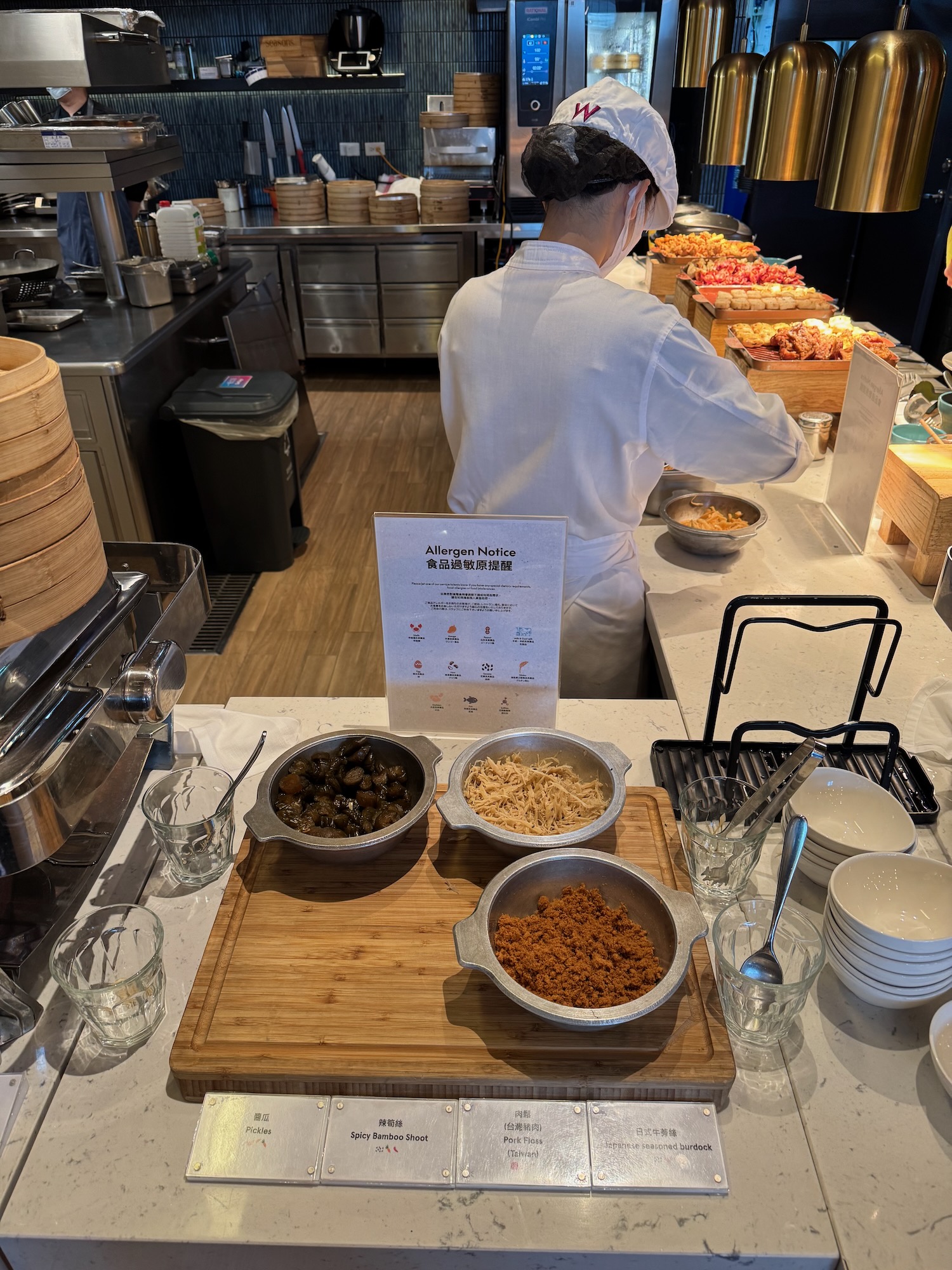 a person in a white uniform cooking food in a kitchen