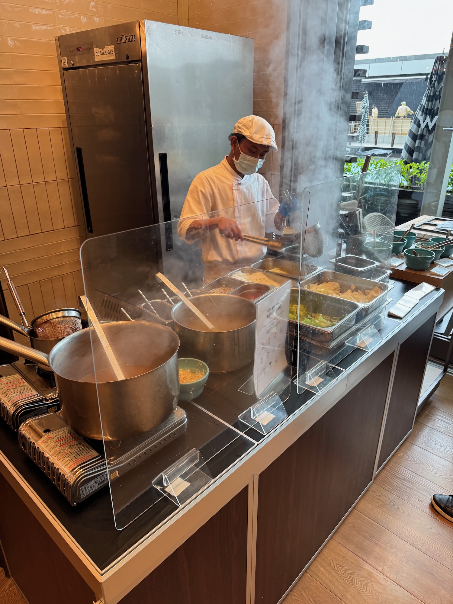 a man cooking food in a kitchen