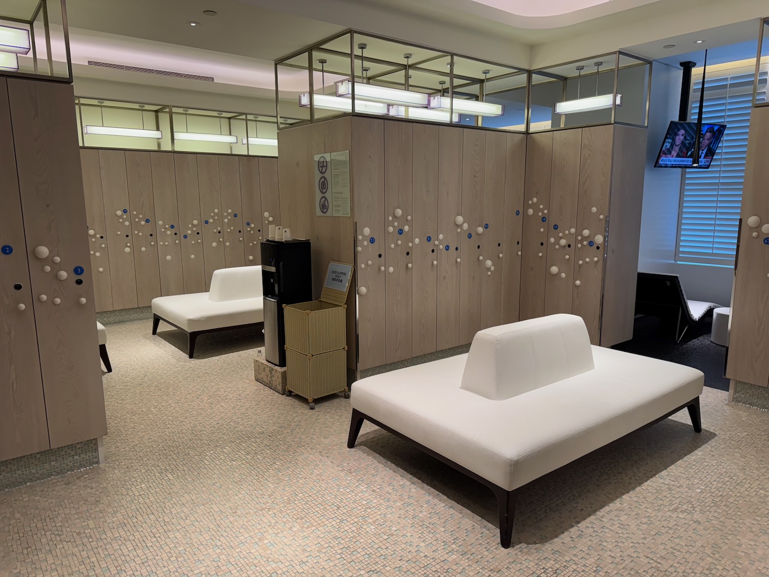 a room with white couches and lockers