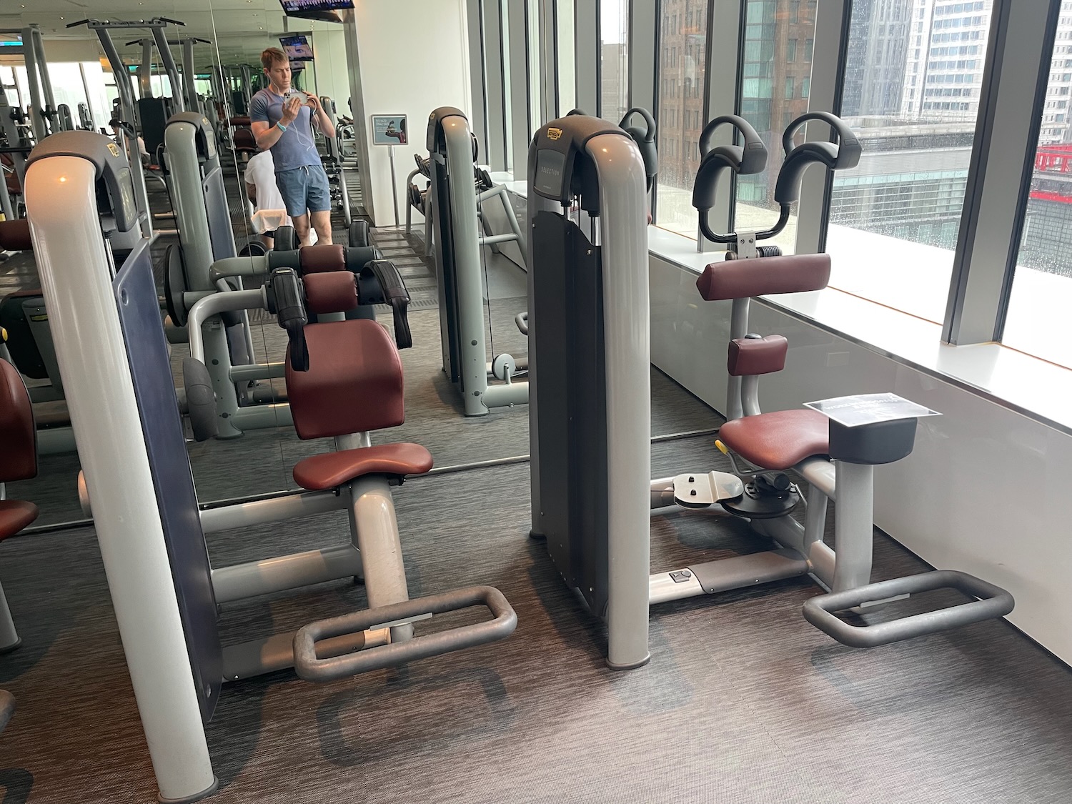 a man taking a picture of a gym equipment