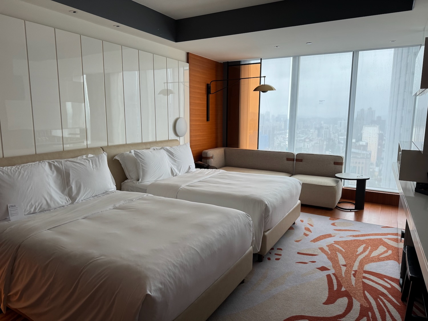 a room with two beds and a large window