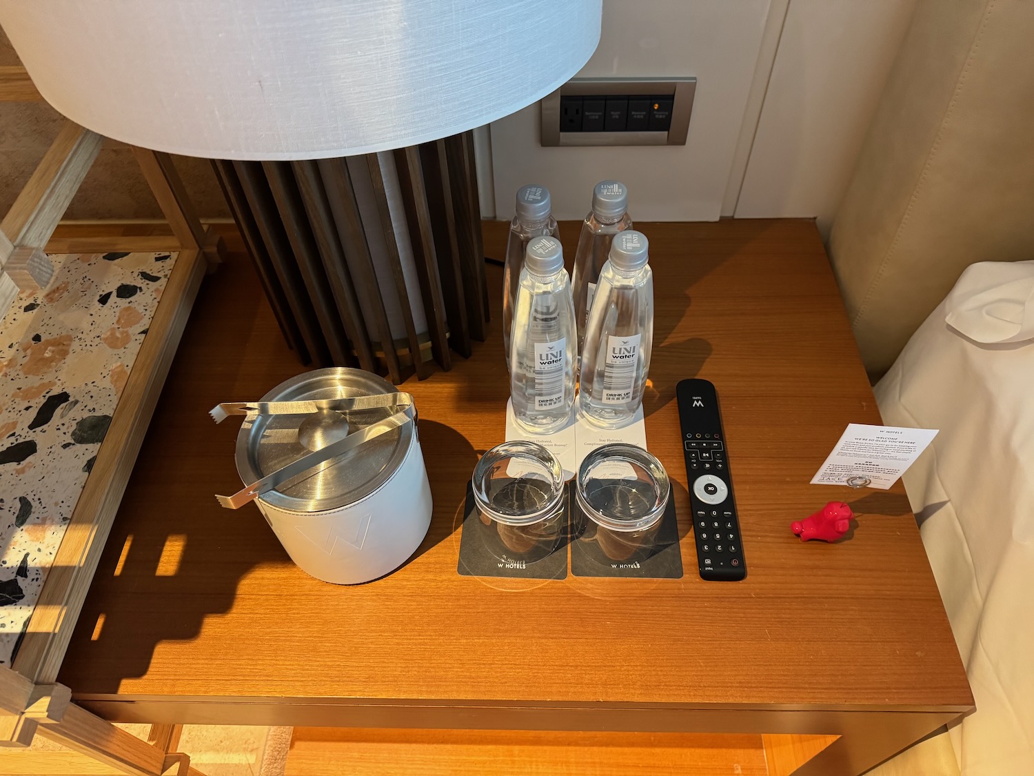 a table with a lamp and a few bottles of water