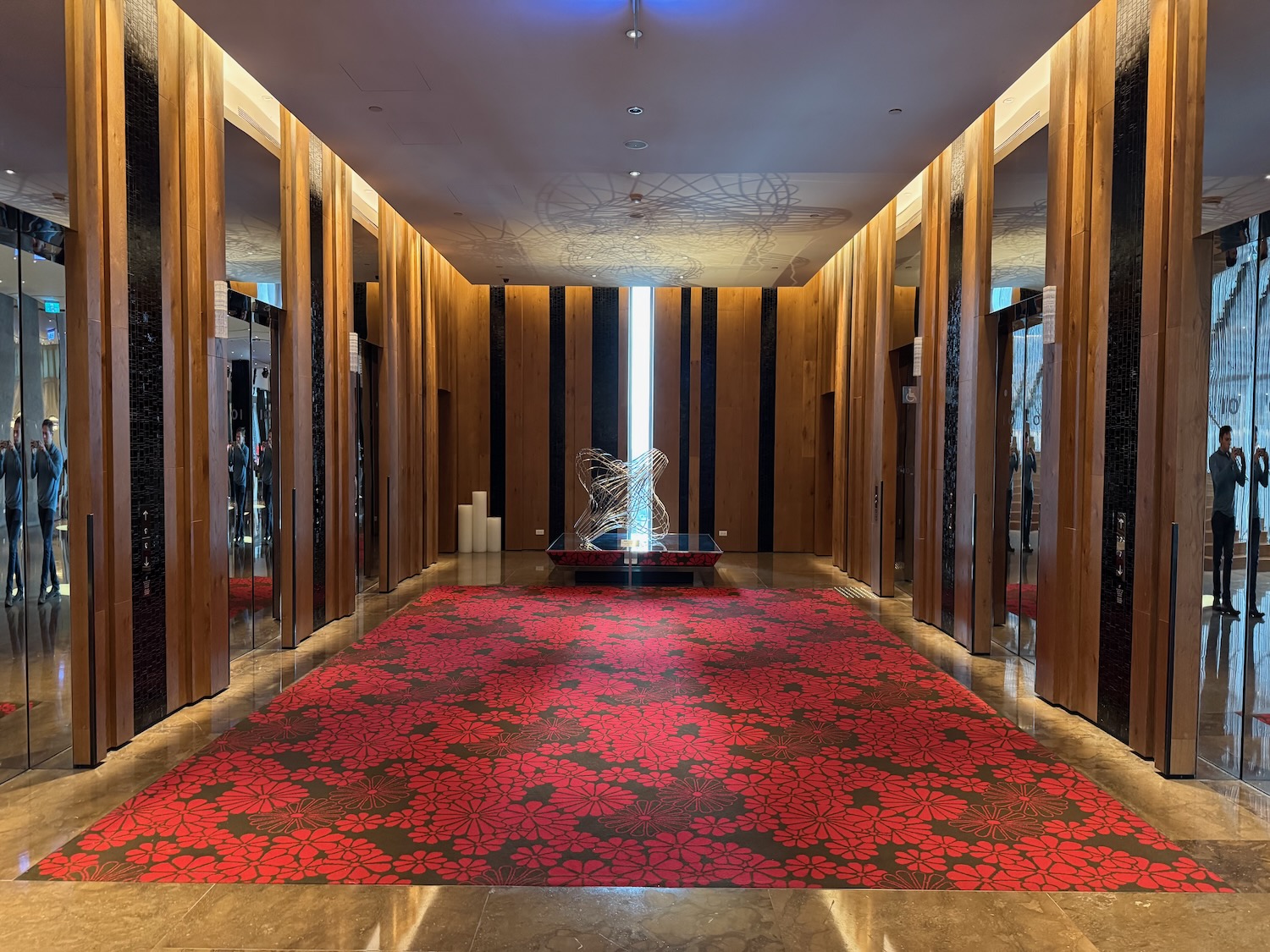 a room with a red carpet and a statue in it