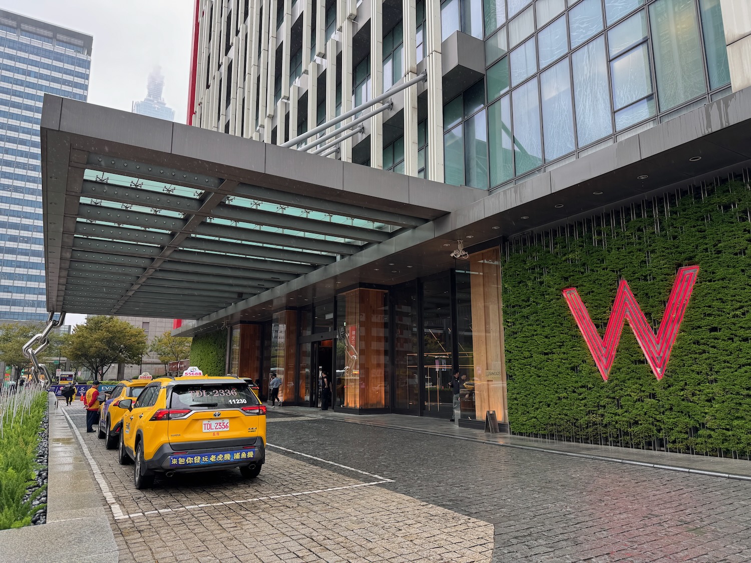 a yellow taxi parked in front of a building