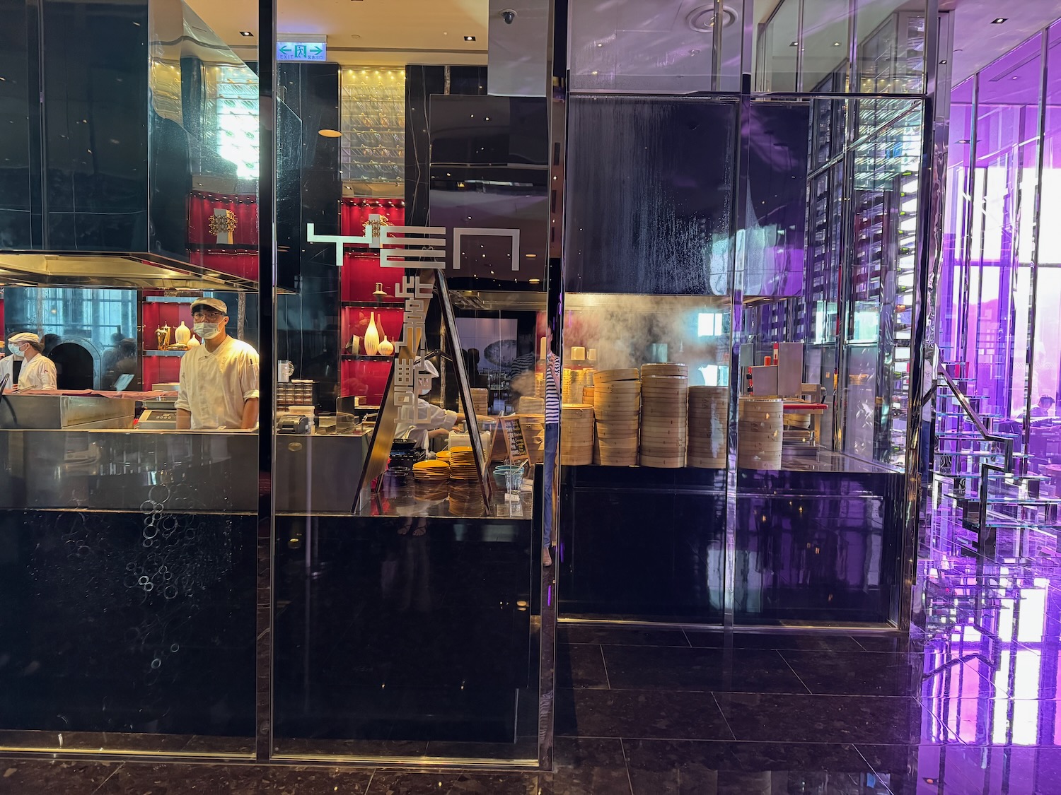 a man in a white uniform behind a glass wall