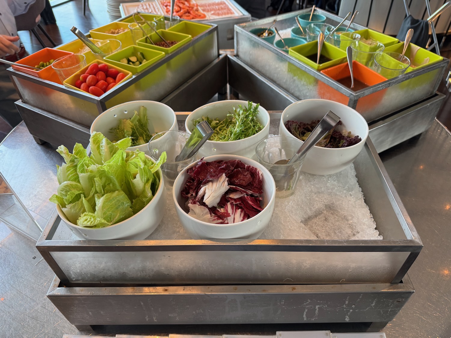 a tray of salad bowls and spoons
