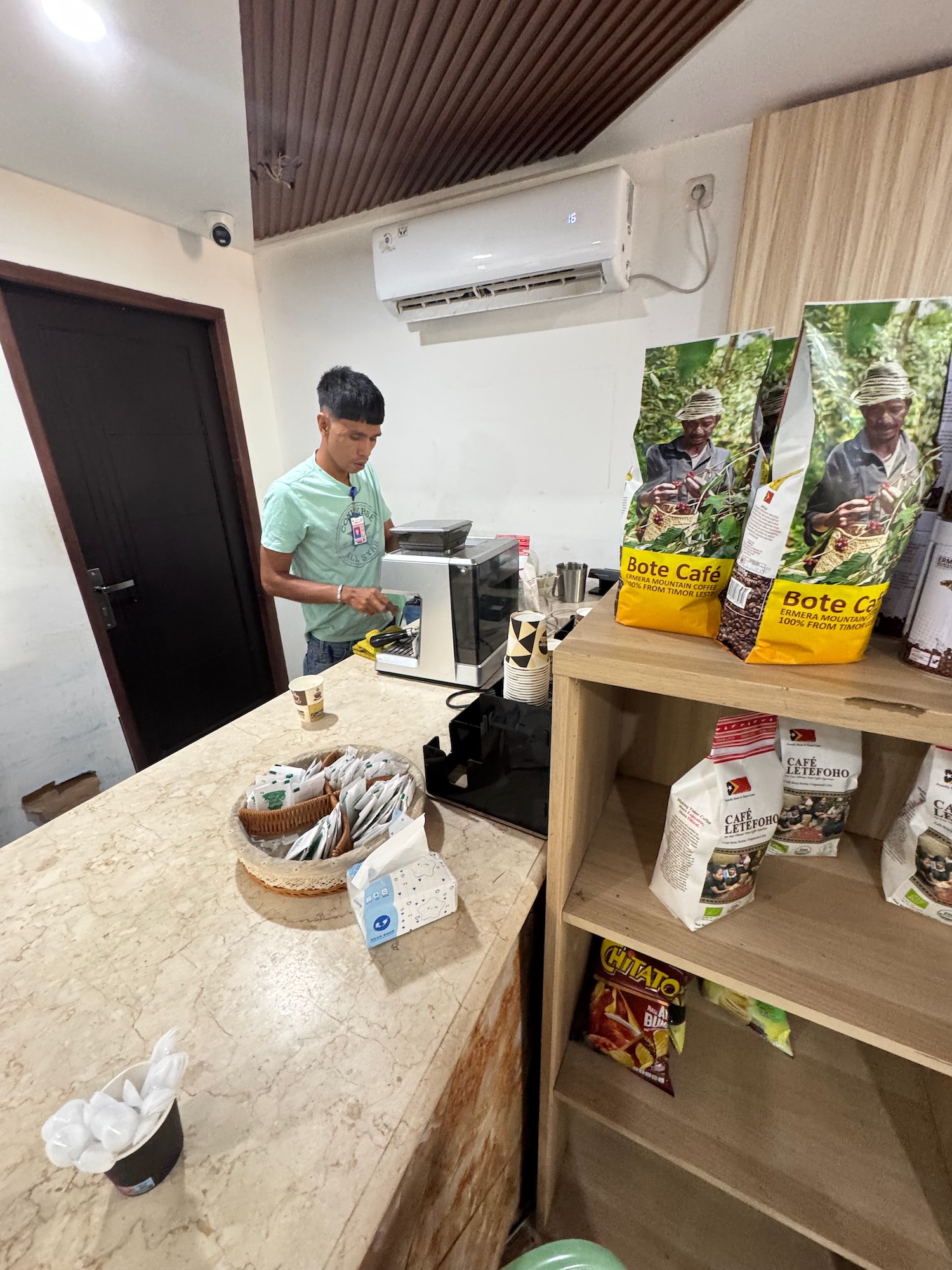 a man standing in a room with a coffee machine