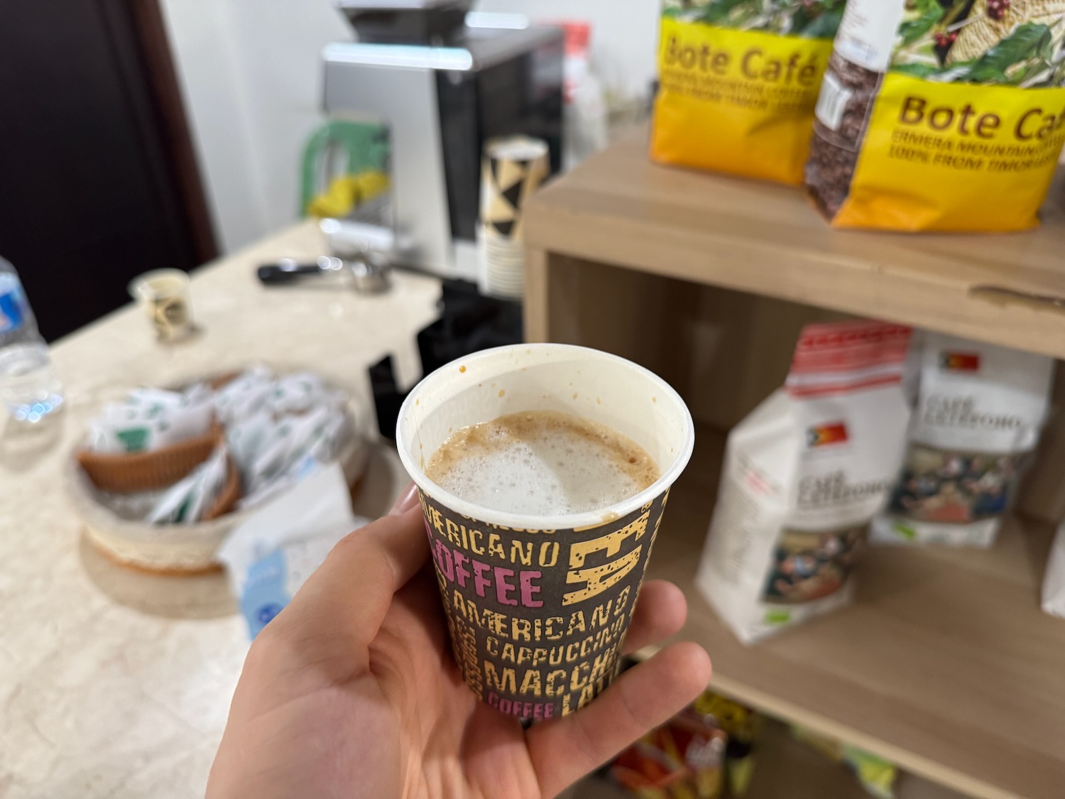 a hand holding a cup of coffee