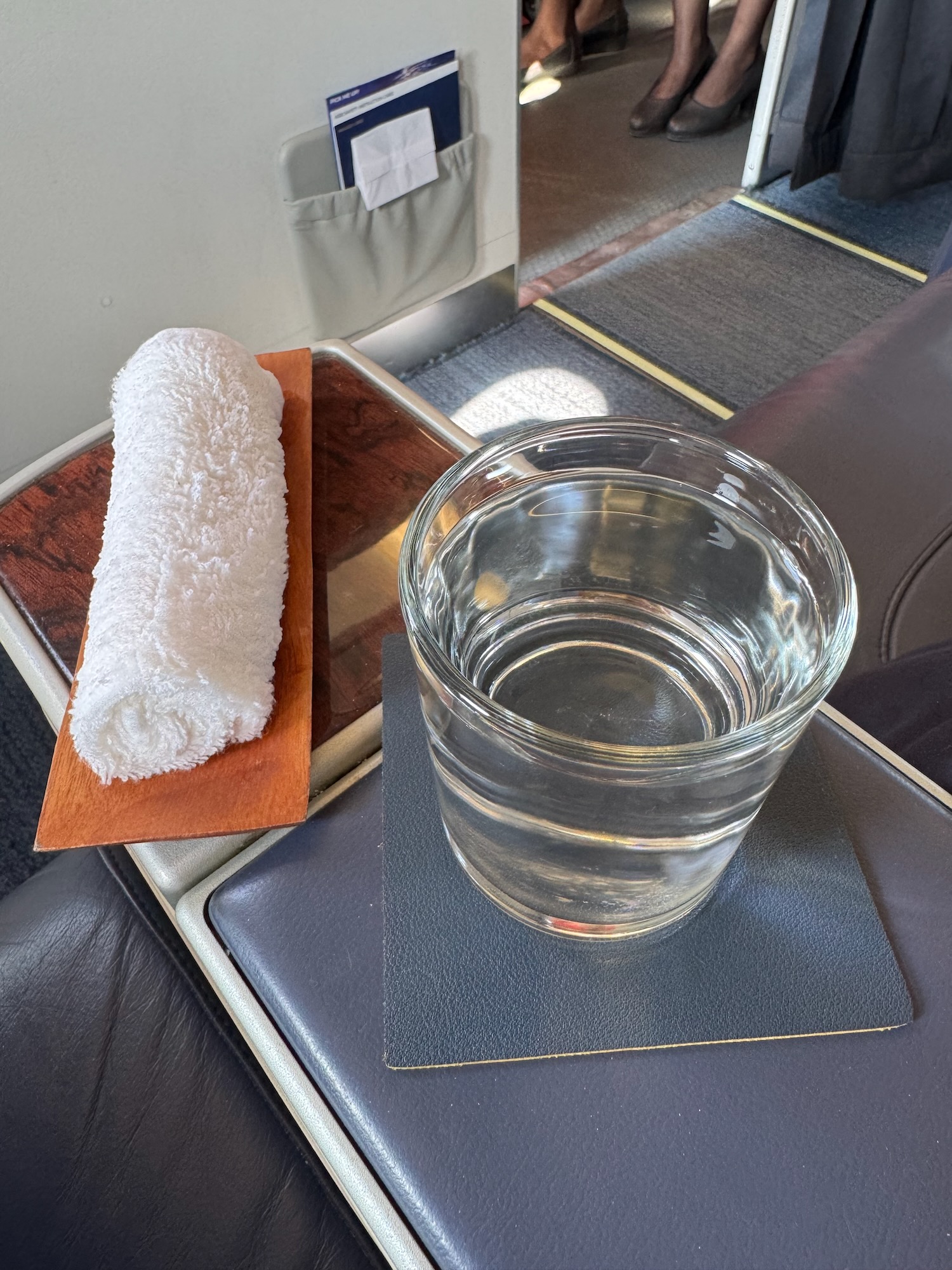 a glass of water and a towel on a tray