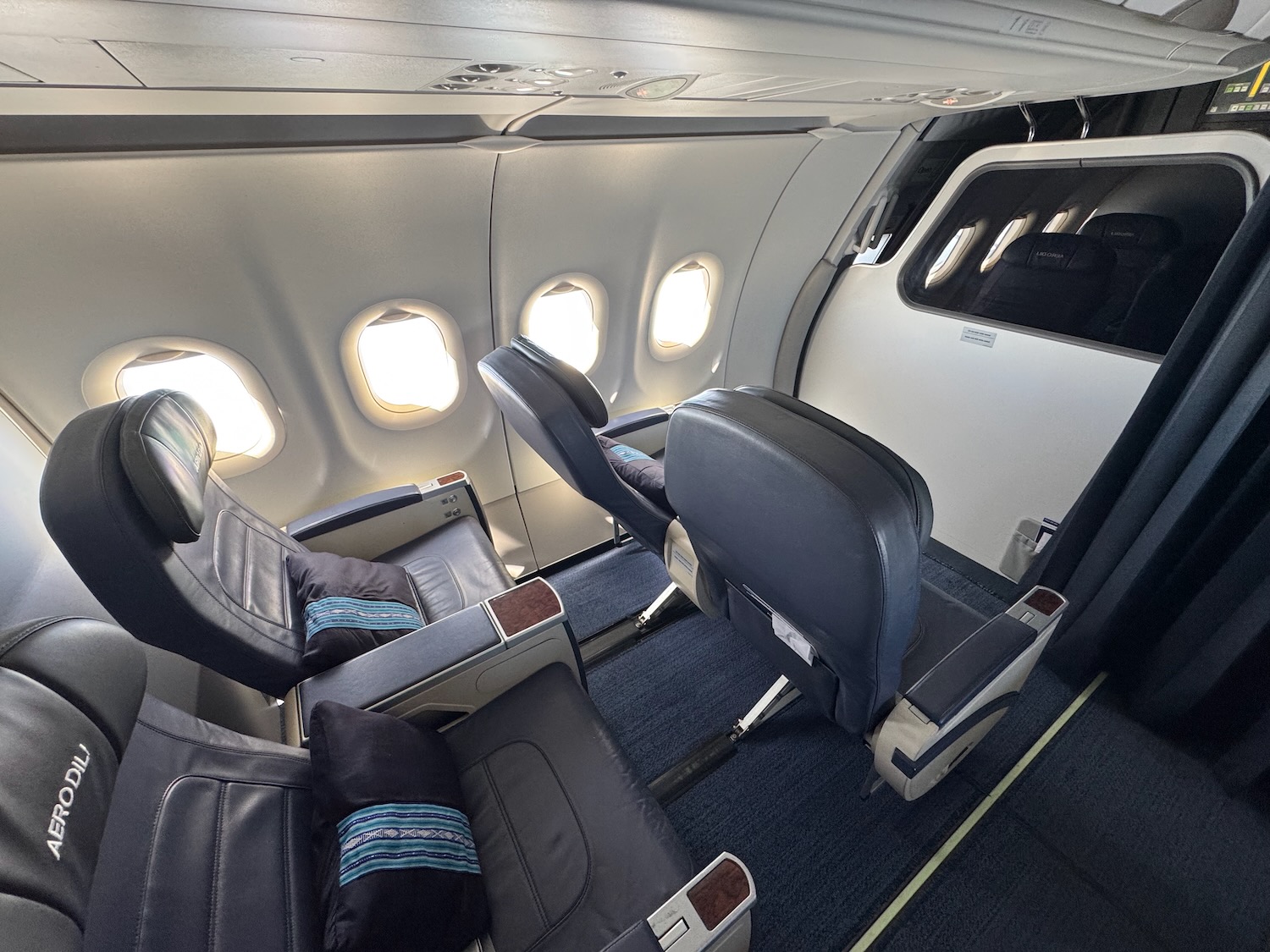 the inside of an airplane with seats and windows