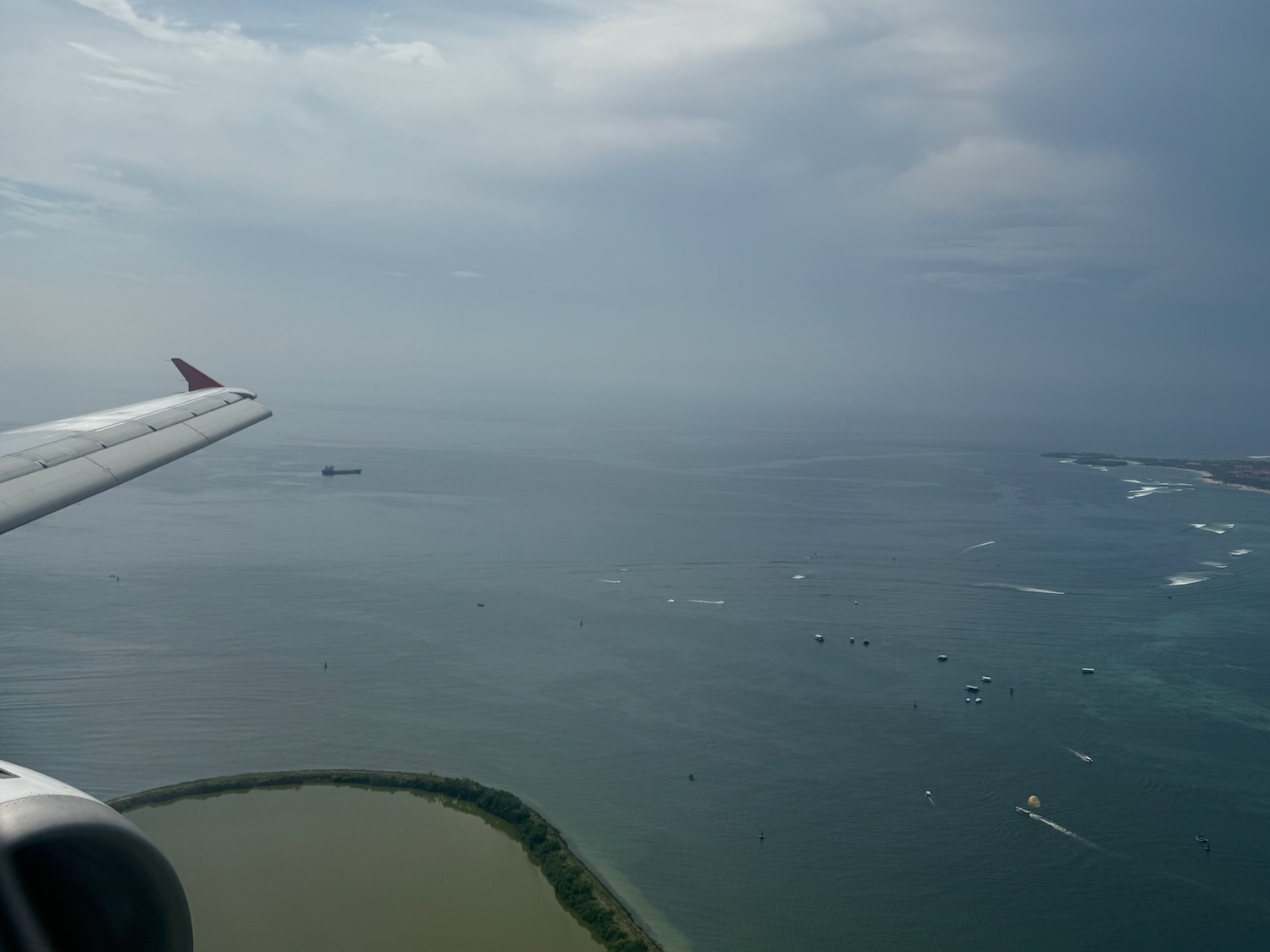 an airplane wing over a body of water