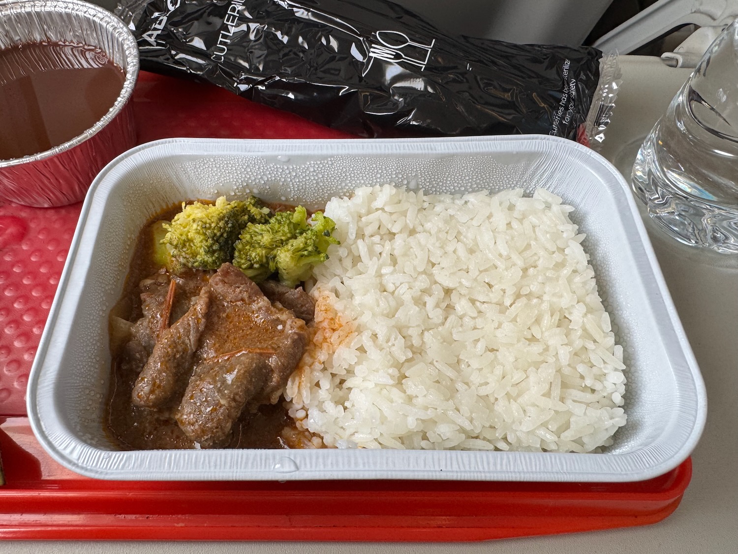 a tray of food with meat and rice