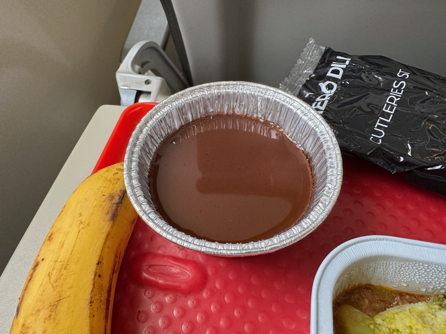 a bowl of chocolate pudding and a banana