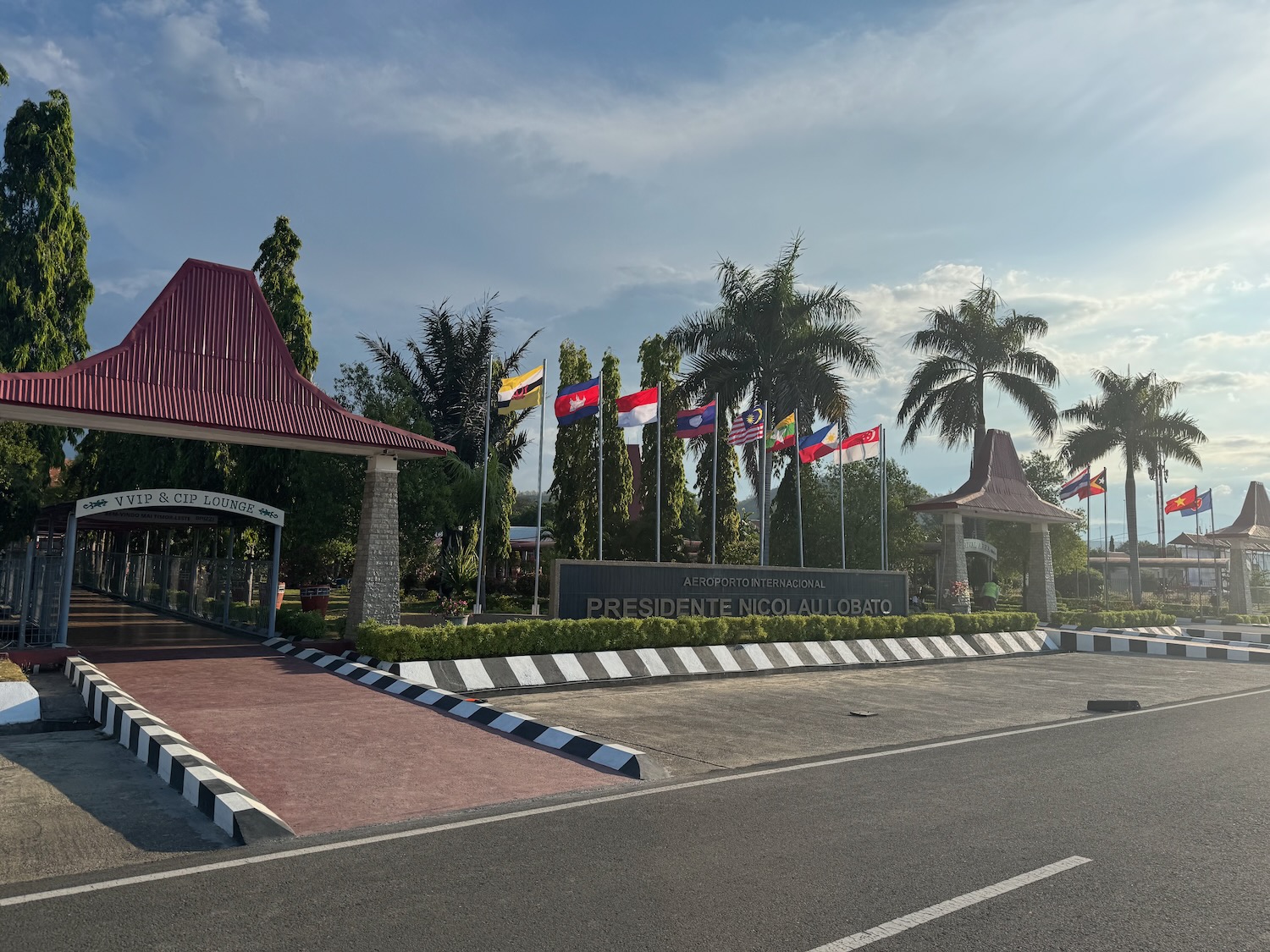 a road with a sign and flags