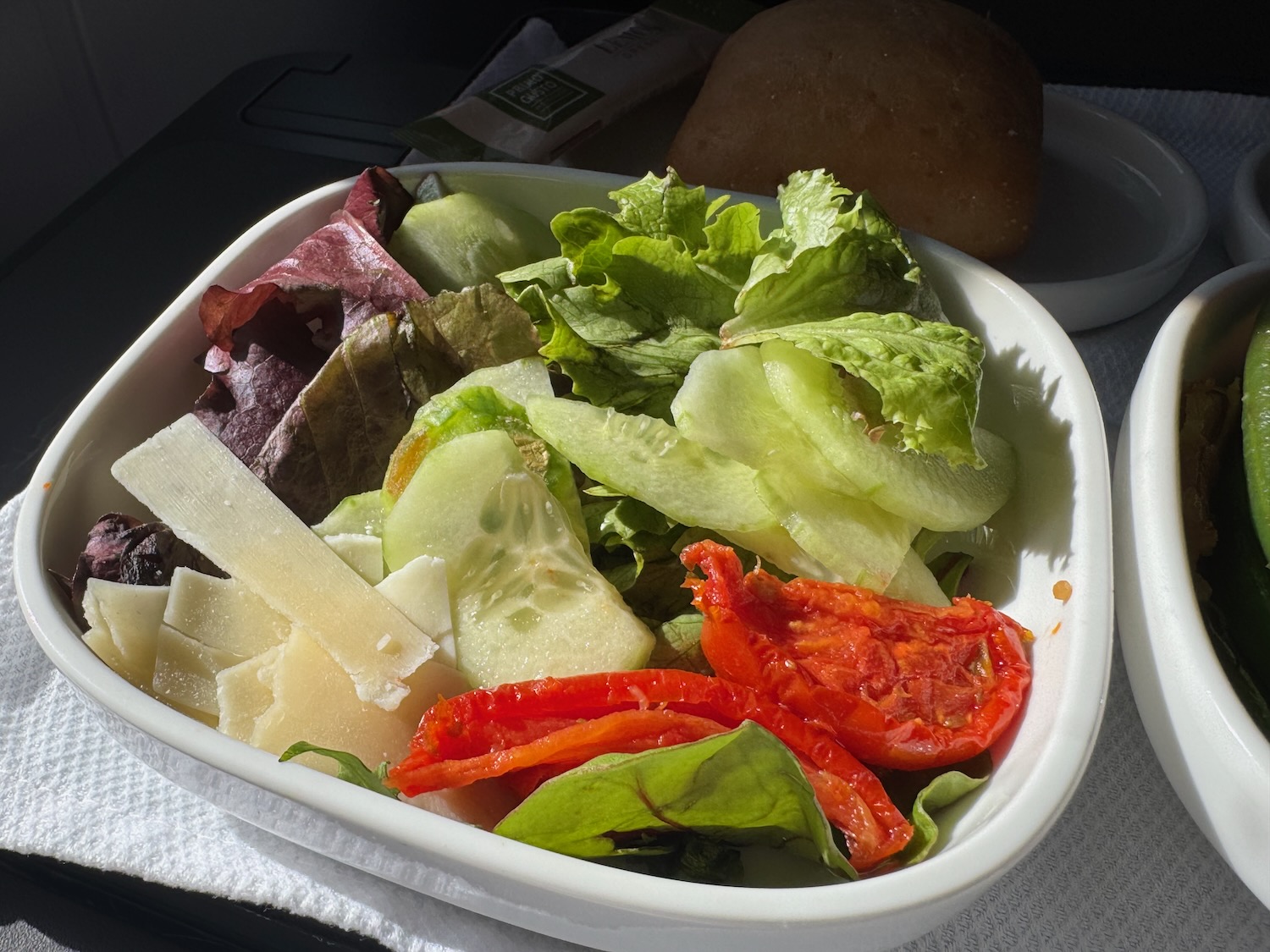a bowl of salad with tomatoes and cheese